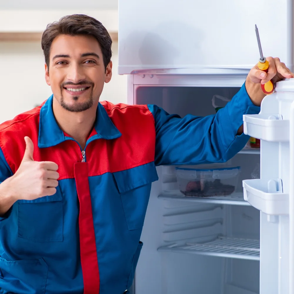 Technician repairing a refrigerator
